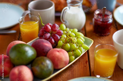 fruits, juice and other food on table at breakfast