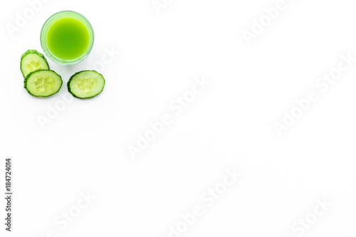Wellness elements. Green detox drinks with cucumber on white background top view copyspace