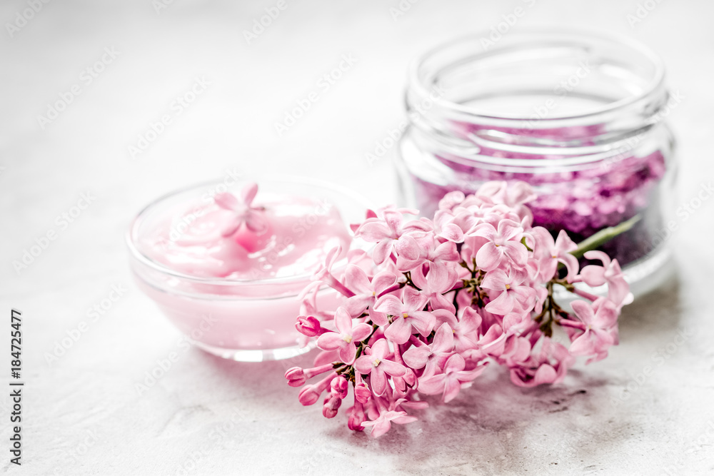 spa cosmetic set with lilac flowers stone desk background spa cosmetic set with lilac flowers stone desk background