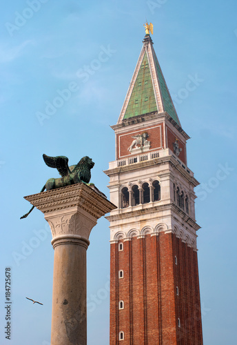 Lion of Venice and San Marco Campanile - St Mark's bell tower in the St Mark's bell tower, located on the Piazza San Marco in Venice, Italy photo