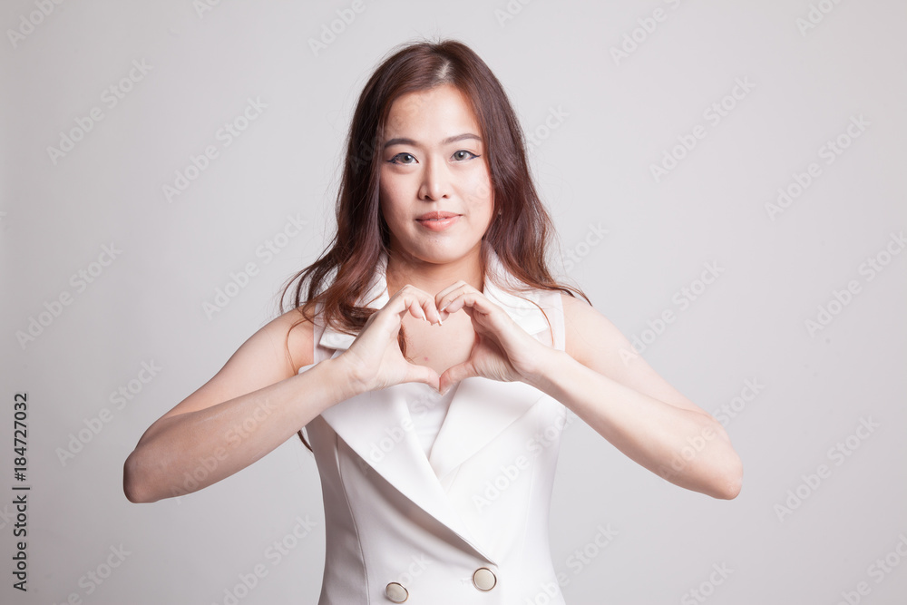 Young Asian woman show heart hand sign. Young Asian woman show heart hand sign.