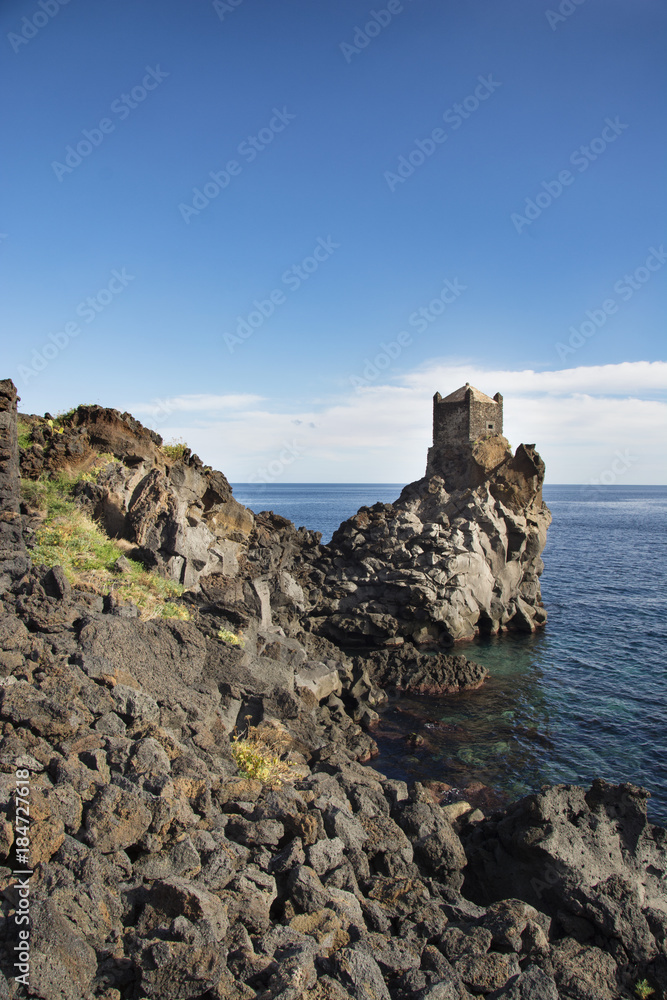 ancient watchtower in lava stone in Sicily