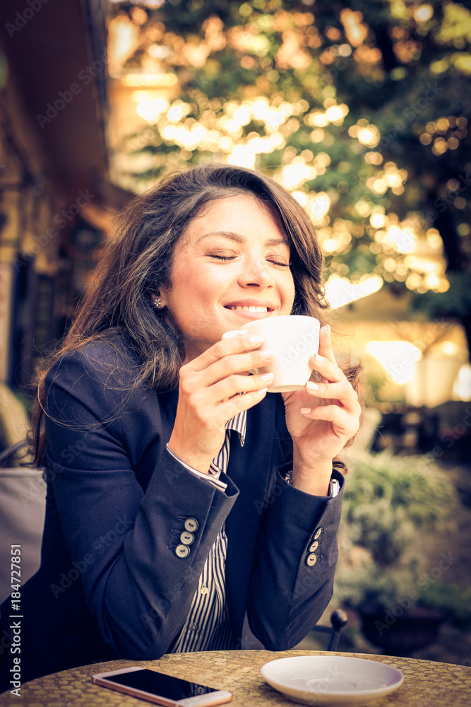 Smiling business woman enjoy in morning coffee.