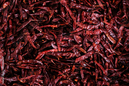 Dried red hot Mexican paprika chili or chillies peppers texture background