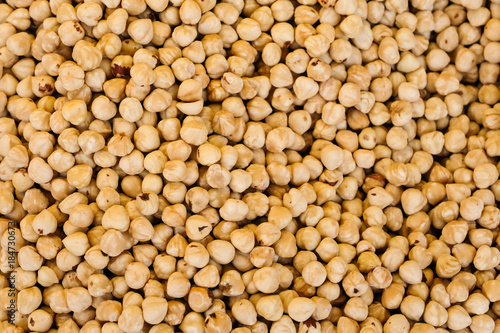 Roasted hazelnuts or filberts nuts heap  texture background  top view.