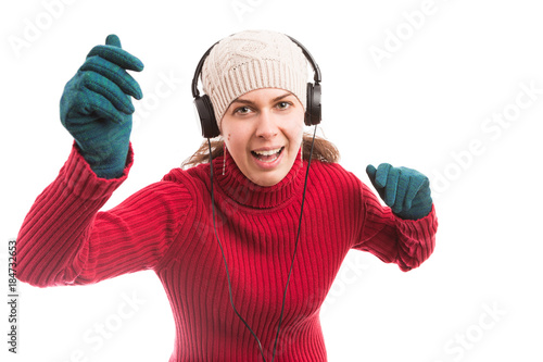 Young woman dancing and listening music on headphones