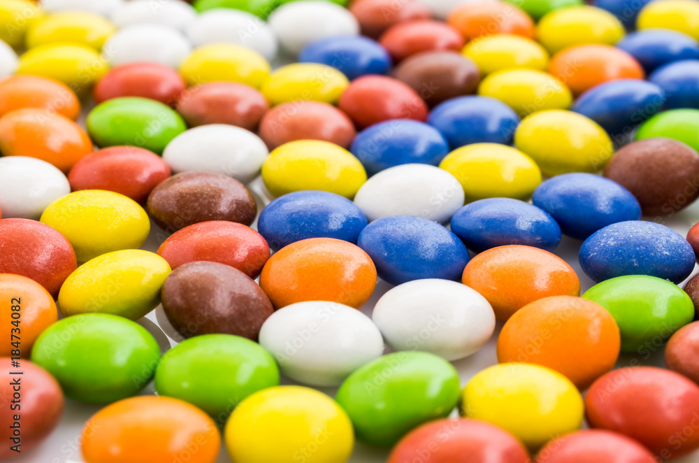 Perspective from a multi-colored dragee. Background with perspective. Sweet colored dragee. Perspective from a multi-colored dragee. Background with perspective. Sweet colored dragee.