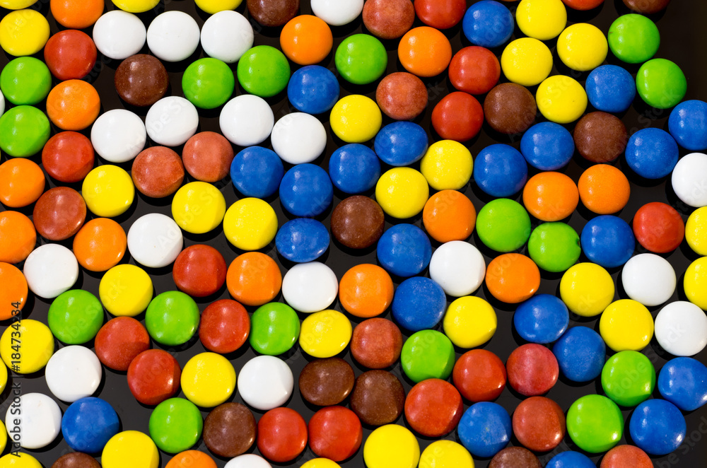 Texture of multi-colored small chocolates. Background of the balls. Multicolored balls. Texture of multi-colored small chocolates. Background of the balls. Multicolored balls.