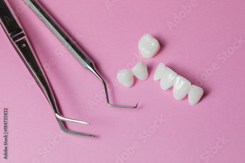 Zircon dentures with dental equipment on a pink background - Ceramic veneers - lumineers photo