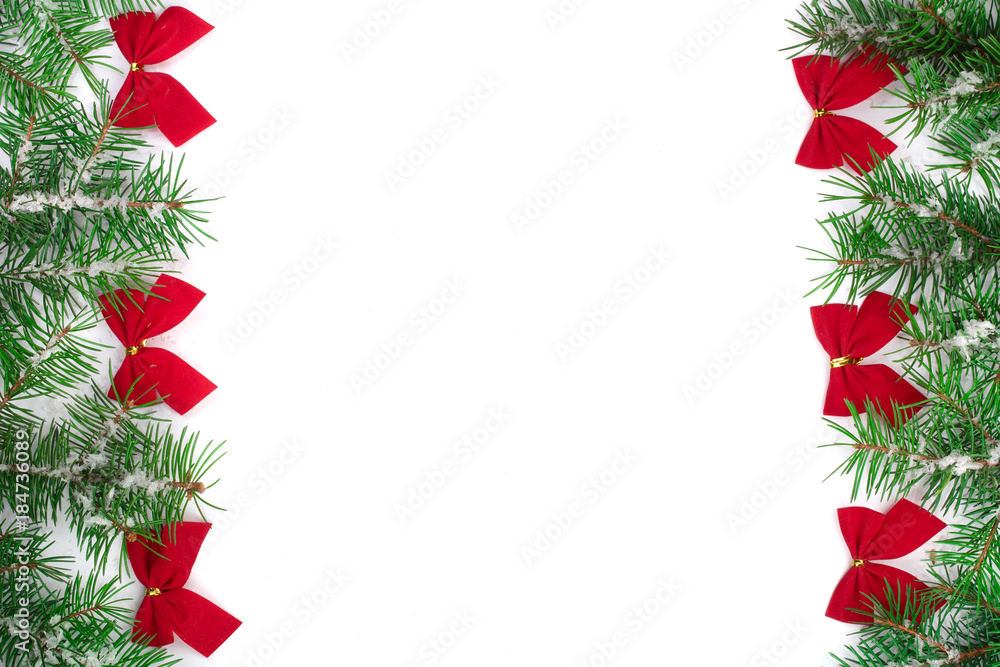 Christmas Frame of Fir tree branch with snow and red bows isolated on white background with copy space for your text Christmas Frame of Fir tree branch with snow and red bows isolated on white background with copy space for your text