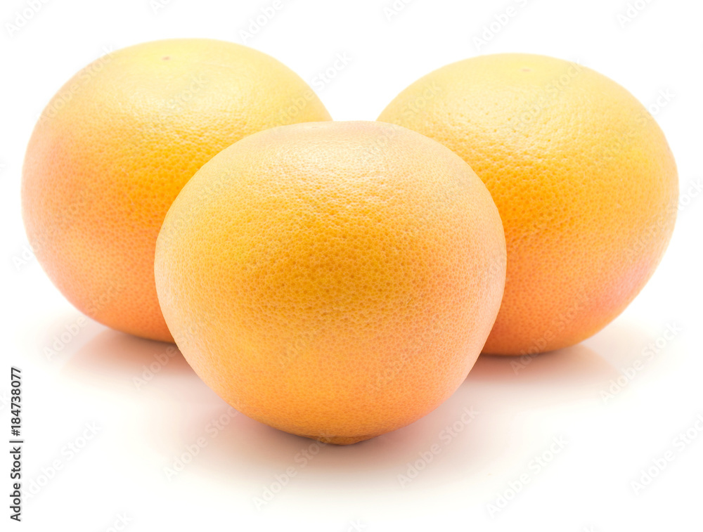 Three red grapefruits isolated on white background. Three red grapefruits isolated on white background.