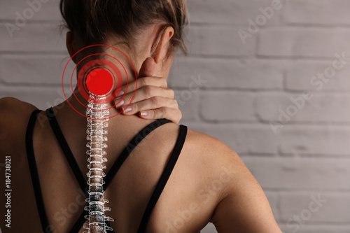 Woman suffering from back and neck pain. Incorrect sitting posture problems, Muscle spasm, rheumatism. Pain relief , chiropractic concept. Sport exercising injury