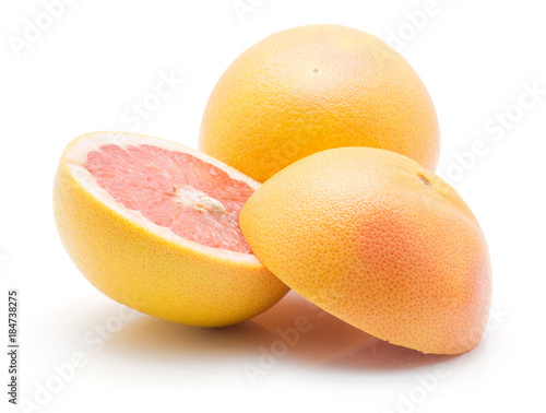Sliced red grapefruit and one whole isolated on white background. photo