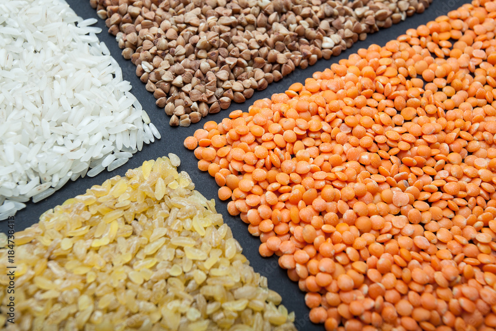 Set of cereals on a black background: lentils, rice, buckwheat and bulgur. Set of cereals on a black background: lentils, rice, buckwheat and bulgur.
