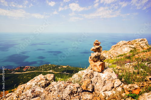 Stone pyramid in the mountains over the sea . photo