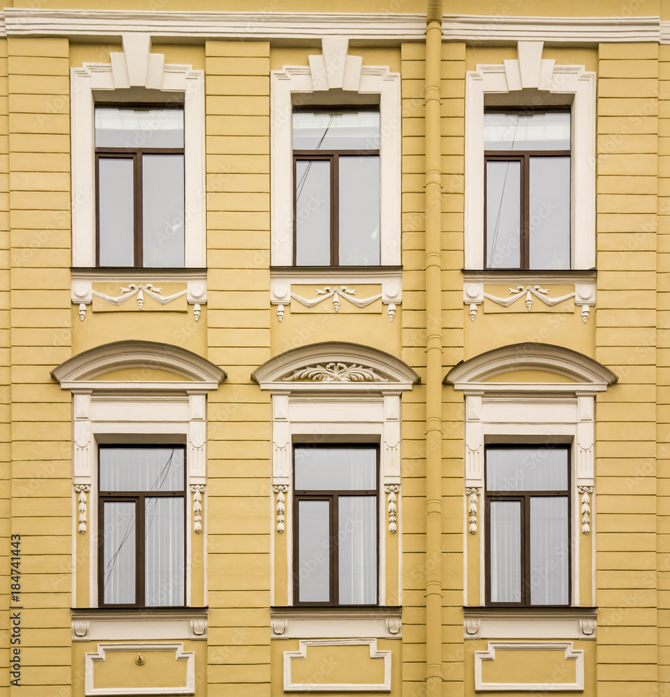 The historical façade is decorated with bas-relief columns and patterns in the city of St. Petersburg