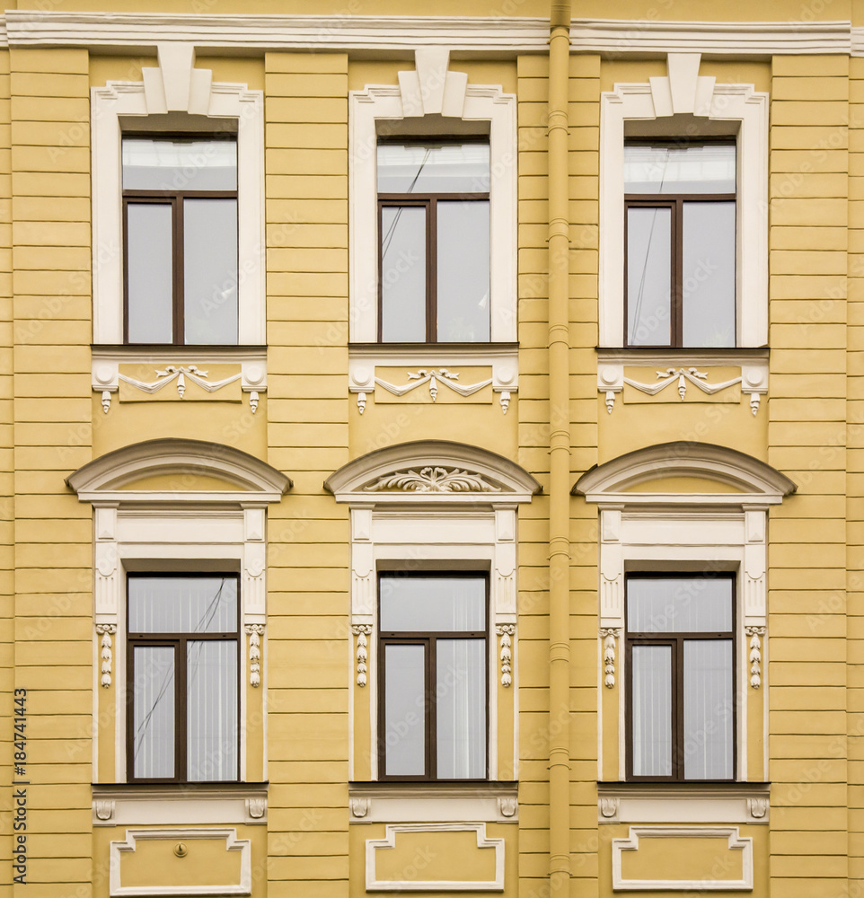 The historical façade is decorated with bas-relief columns and patterns in the city of St. Petersburg The historical façade is decorated with bas-relief columns and patterns in the city of St. Petersburg