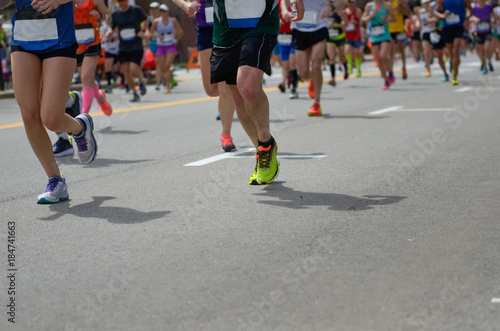 Marathon running race, many runners feet on road, sport, fitness and healthy lifestyle concept 