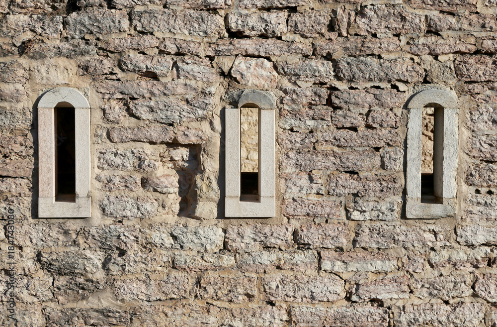 three small windows of a ancient building