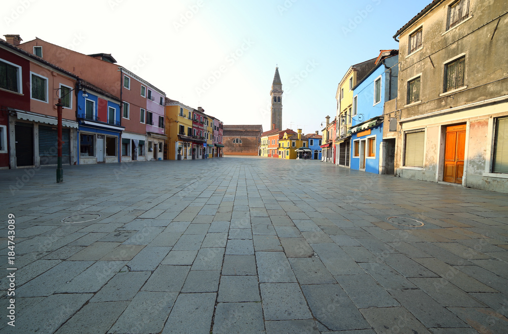 wide street of Burano Island near Venice in ITALY in the early morning