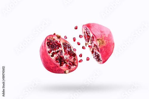 Konstfotografi Pomegranate in flight burst on a white background, isolated