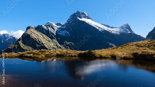 Mountain view and water reflection from the Mackinnon Pass on the Milford Track, New Zealand