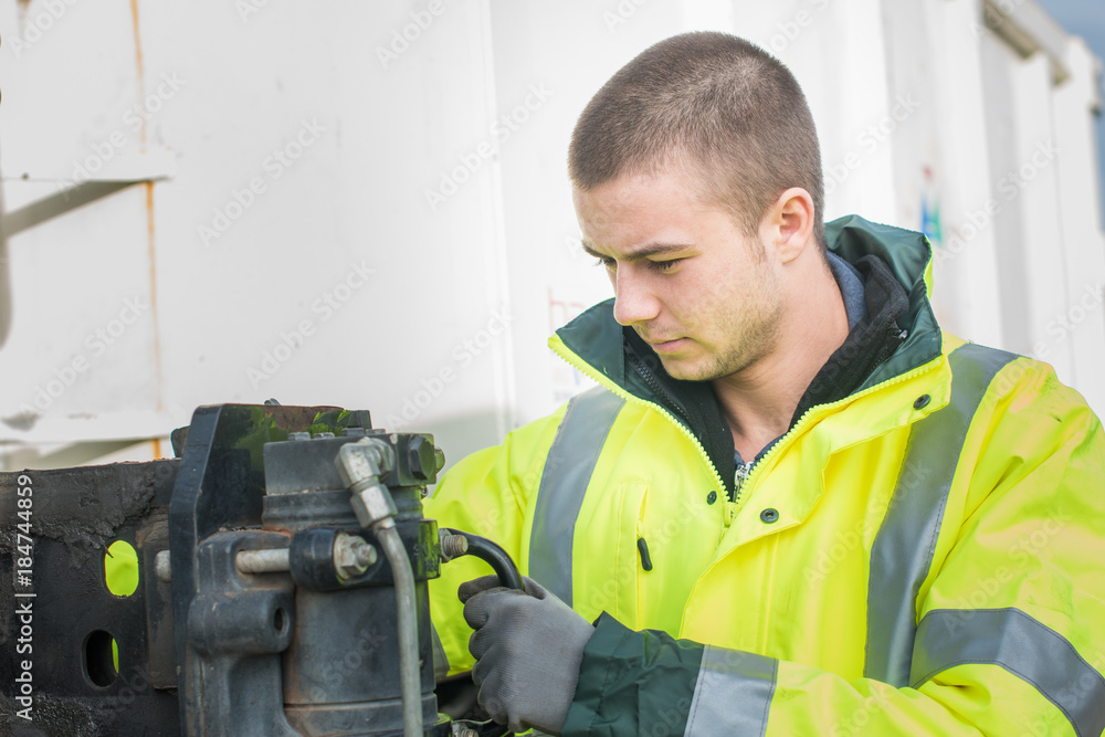 handsome young worker fixing something handsome young worker fixing something