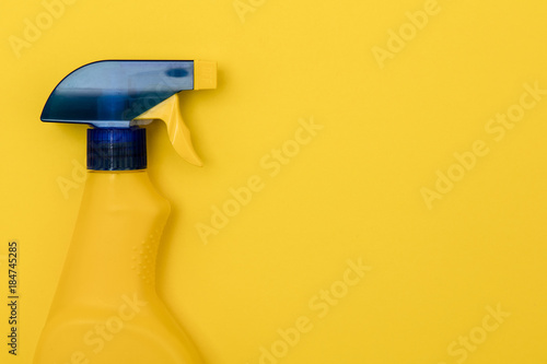 Cleaning spray bottle products on a bright yellow background