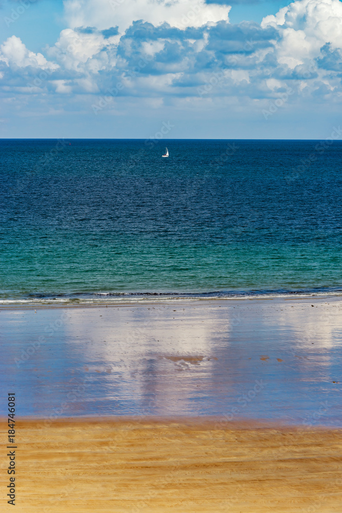 Low tide water on coastline, yellow sand of the beach, Bretagne