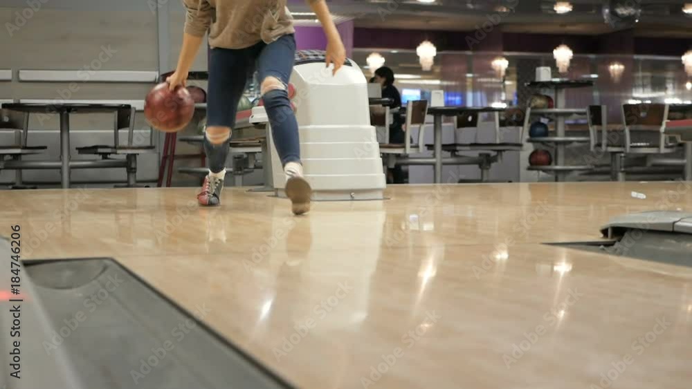 Woman in club for bowling is throwing ball. Woman in club for bowling is throwing ball.