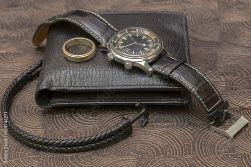 a business man leather accessory, closeup. Wallet, strap, handstrap and mobile phone with case