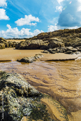 Low tide water on coastline, yellow sand of the beach, Bretagne