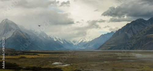 NEW ZEALAND – MARCH 2016 : Animated shot of beautiful landscape in Glentanner / Mount Cook National Park with bird flying in view photo