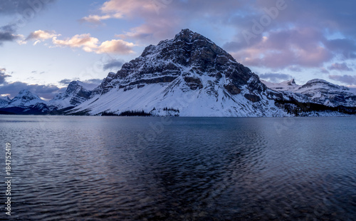 Canadian Rockies reflected in Bow Lake before sunrise in Banff National Park, Alberta
