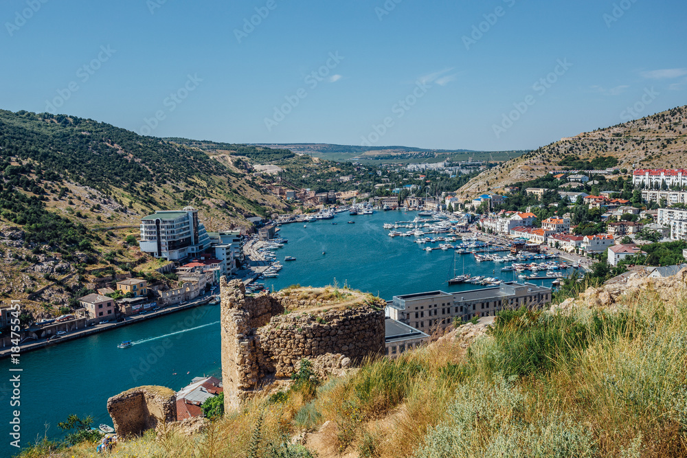 Beautiful view of the Black Sea and Balaklava Bay. Panorama view to city, ships and port. View from Cembalo fortress