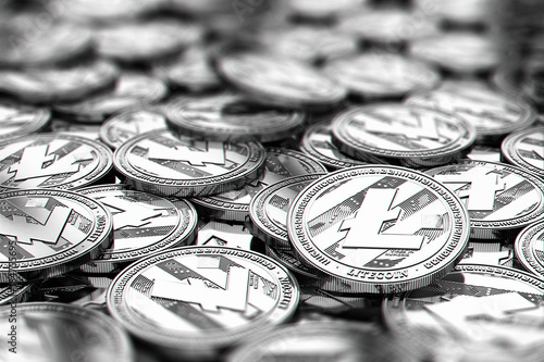 Stack of silver Litecoin coins in blurry closeup with copy space above in blurred area. 3D rendering photo