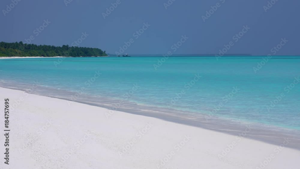 Island at maldivian atoll in Indian Ocean. Wild and uninhabited shore. Getaways destinations Island at maldivian atoll in Indian Ocean. Wild and uninhabited shore. Getaways destinations