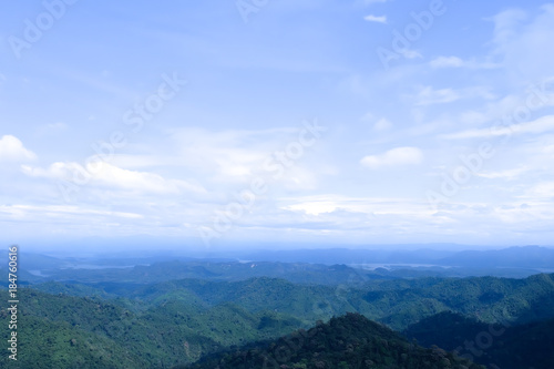 Beautiful mountain landscape, with mountain peaks covered with forest and a cloudy sky