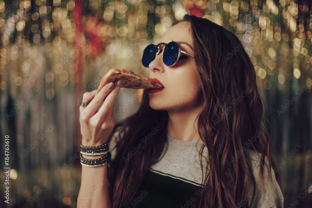 Girl eating tasty pizza