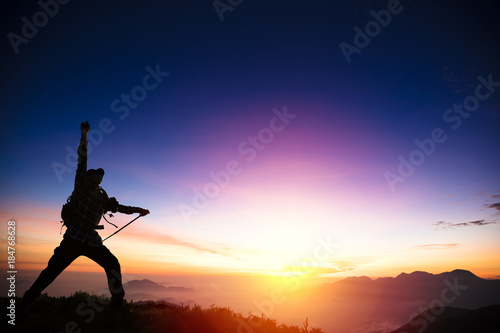 man on the mountain and watching sunrise