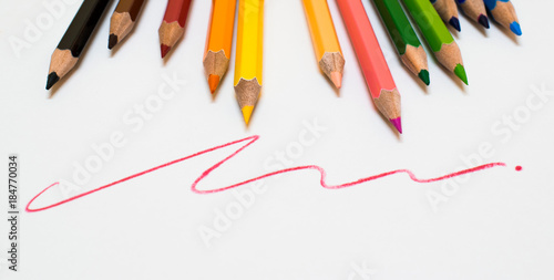 A lots of color pencil on white background with red line