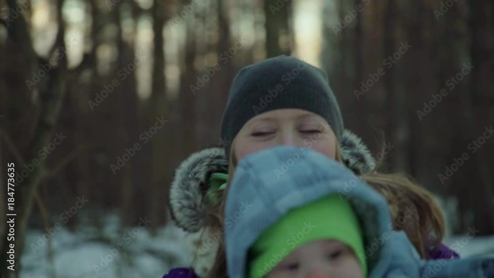 cute boy smiling for mother, Little kid on hands of mother, child dressed in carnival costume of Santa Claus, baby celebrates Christmas holidays mother playing with her son in winter cute boy smiling for mother, Little kid on hands of mother, child dressed in carnival costume of Santa Claus, baby celebrates Christmas holidays mother playing with her son in winter