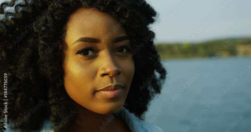 Close up of the African American beautiful woman with curly hair ...
