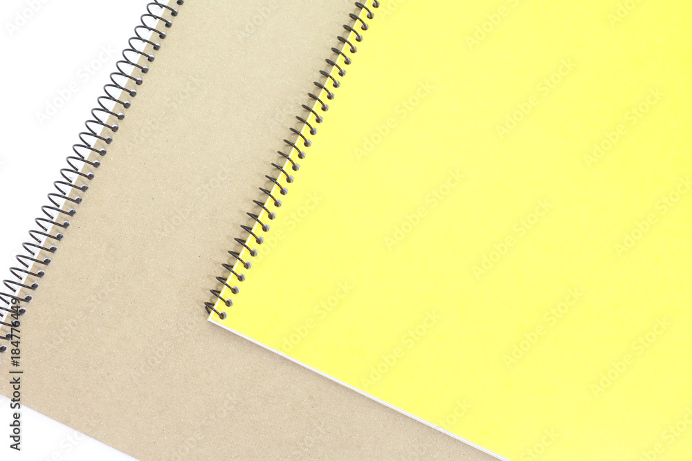 Yellow note book cover and brown note book on white background Yellow note book cover and brown note book on white background