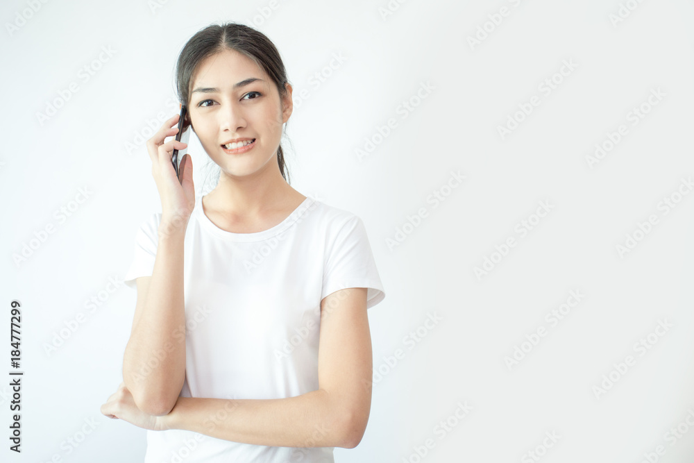 Portrait of Attractive Asian Woman using smartphone with smiling on white background. Portrait of Attractive Asian Woman using smartphone with smiling on white background.