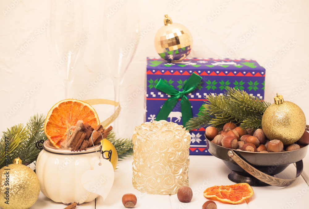 Hazelnuts in veramic jar with cinnamon sticks, spruce tree and oranges. Toned photo, close up. Hazelnuts in veramic jar with cinnamon sticks, spruce tree and oranges. Toned photo, close up.
