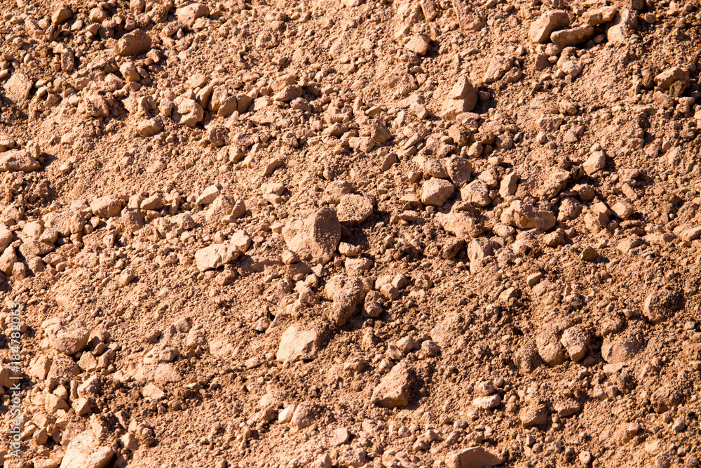 Red clay soil on nature as a background Red clay soil on nature as a background