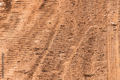 Traces from the car on the red clay soil © schankz