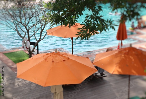 blurred swimming pool with umbrellas © oilslo