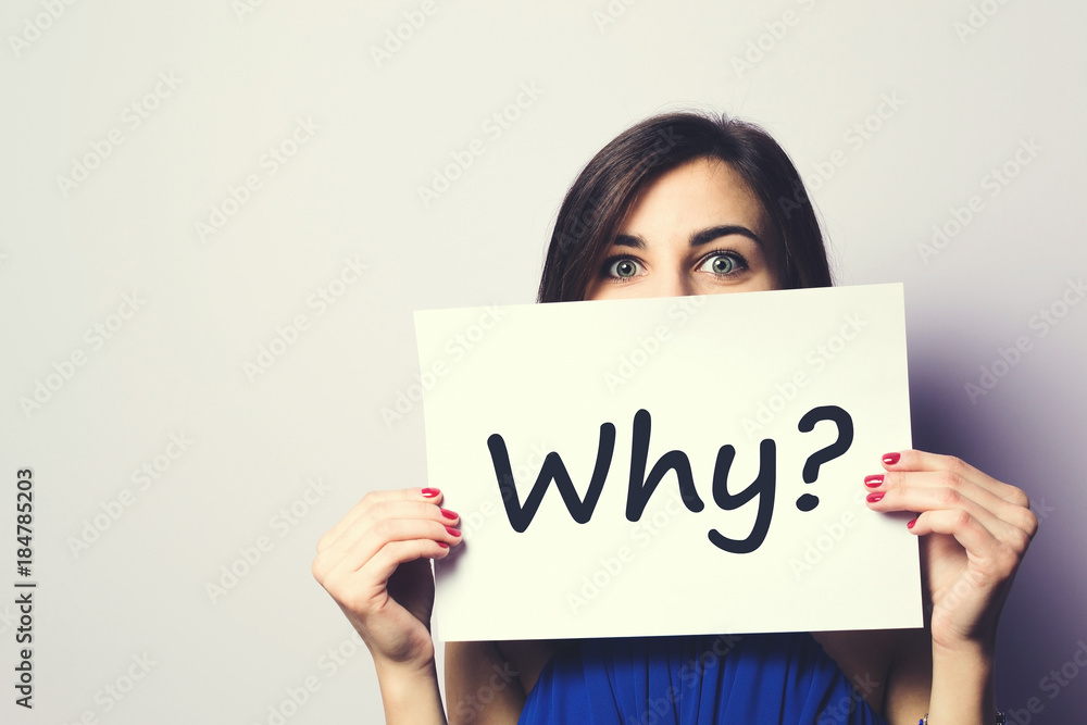 Girl holding a signboard with a question mark Girl holding a signboard with a question mark